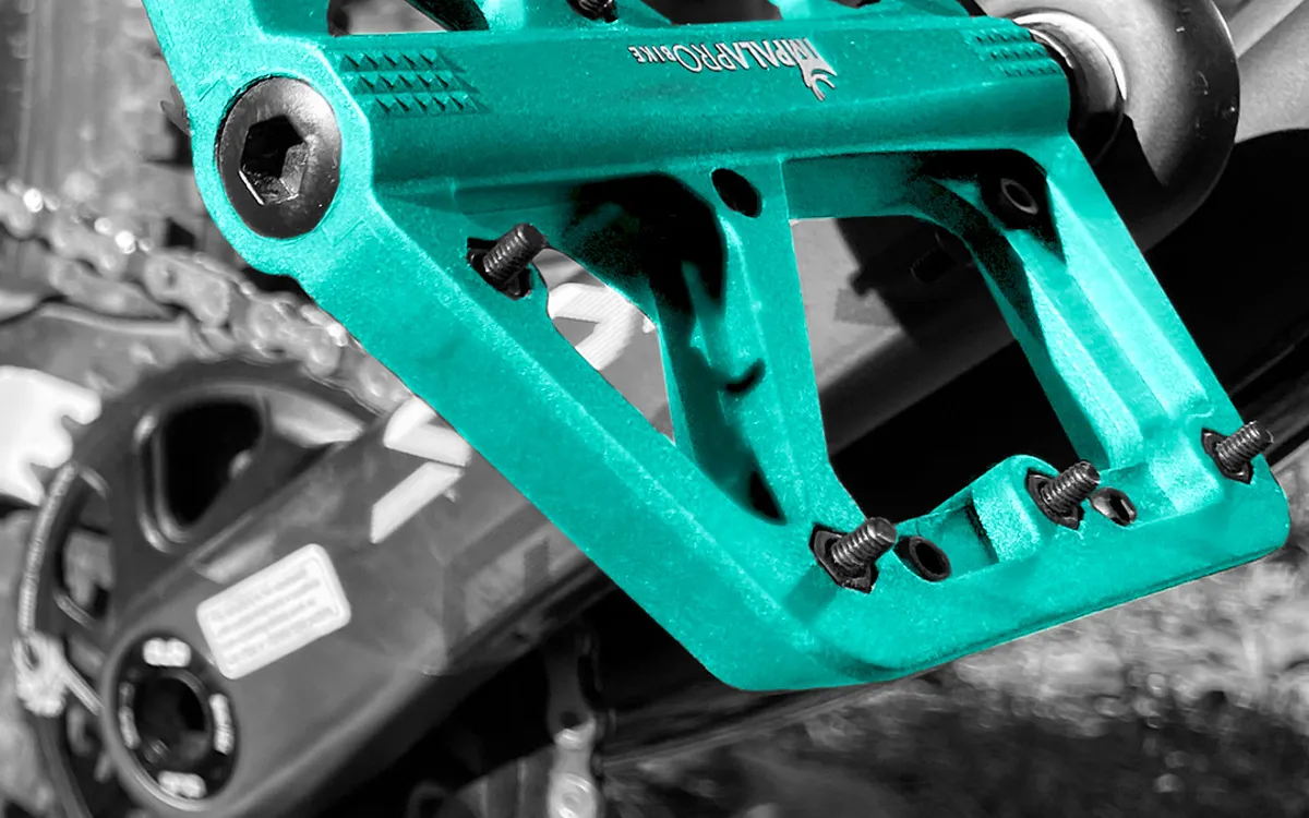 Turquoise nylon flat pedal fitted to a mountain bike
