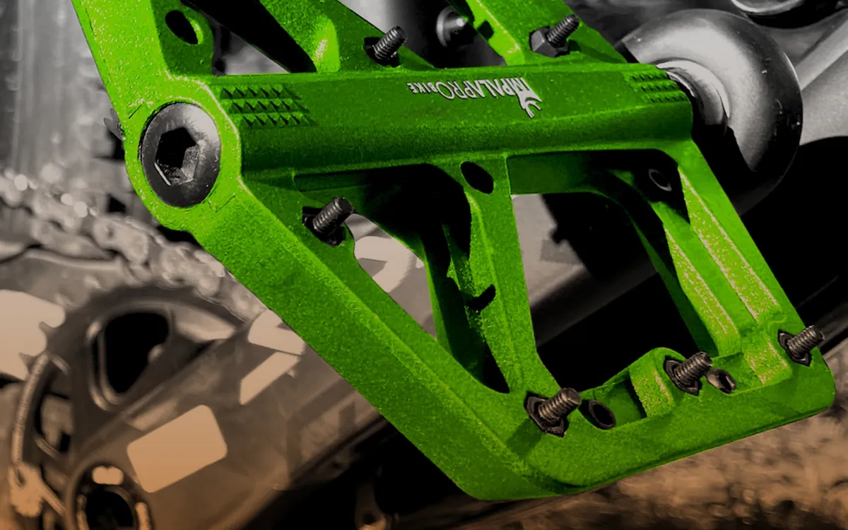 Close-up of the pins on a green nylon flat pedal